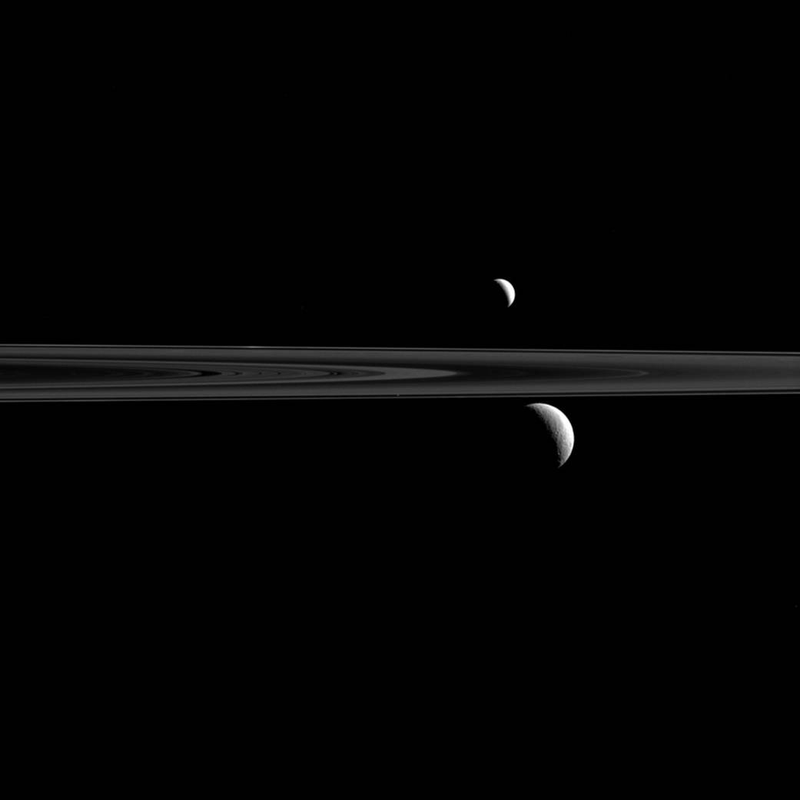 Illustration for article titled Can You Find the Third Moon in this Glorious View from Saturn?